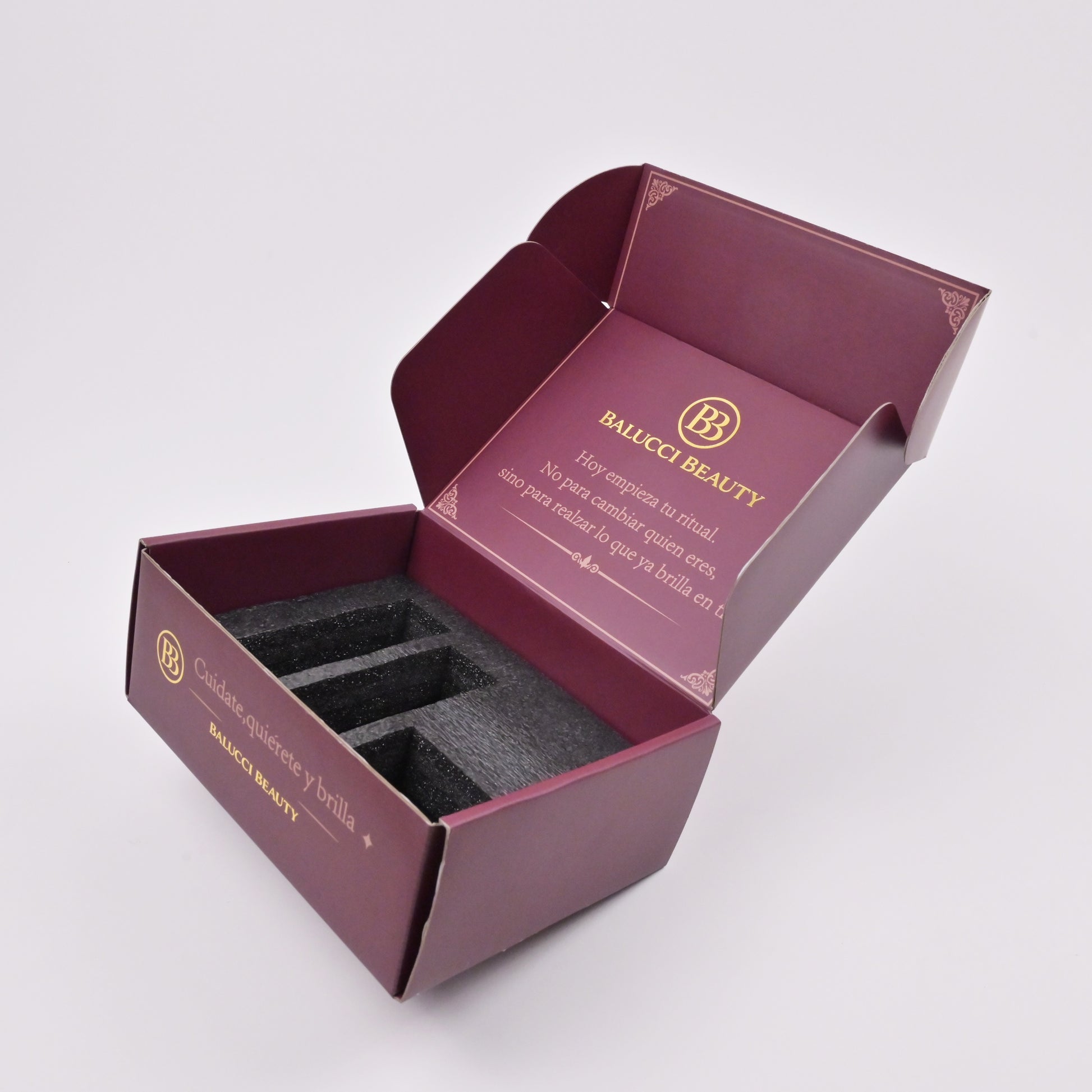 Burgundy gift box with metallic gold logo embossing close-up detail
