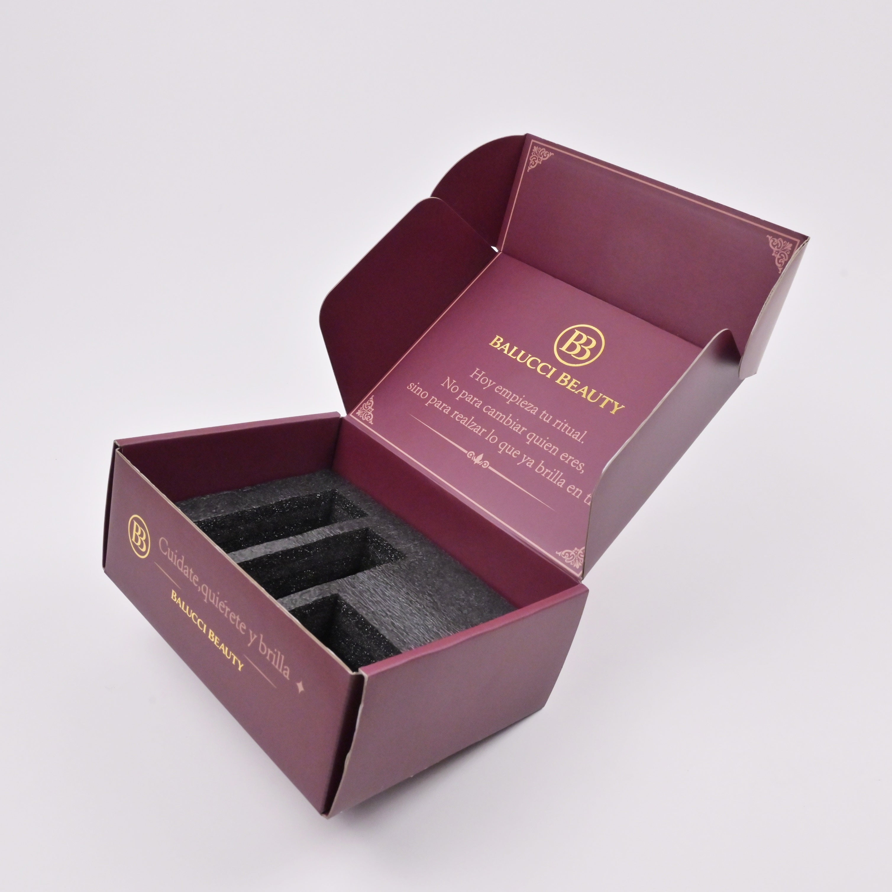Burgundy gift box with metallic gold logo embossing close-up detail