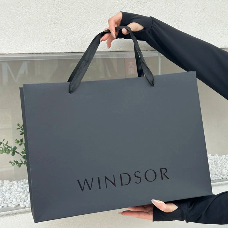 Professional black art paper gift bags with elegant ribbon handles
